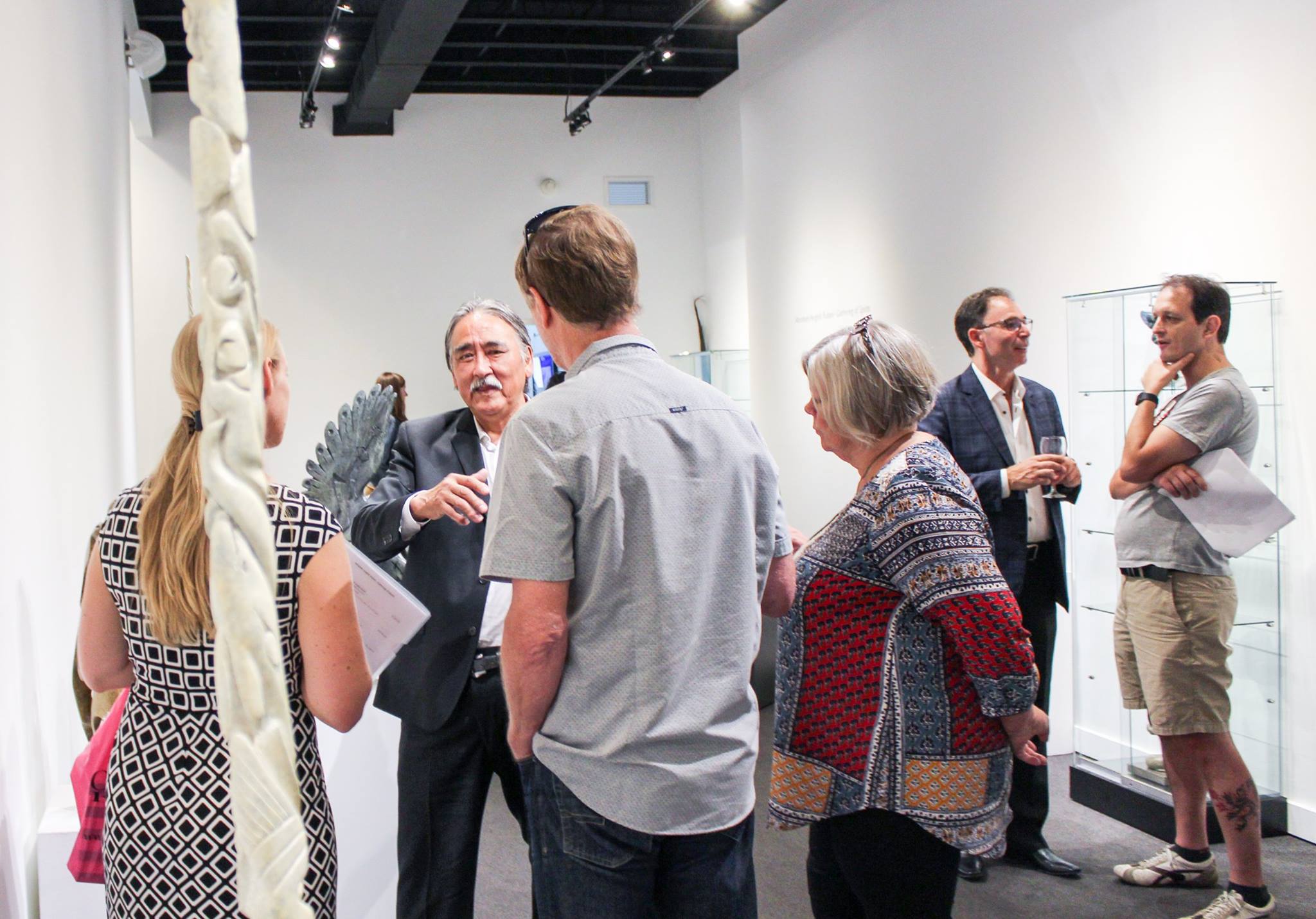 Abraham Anghik Ruben speaks with guests at the opening of his exhibition at Feheley Fine Arts in Toronto